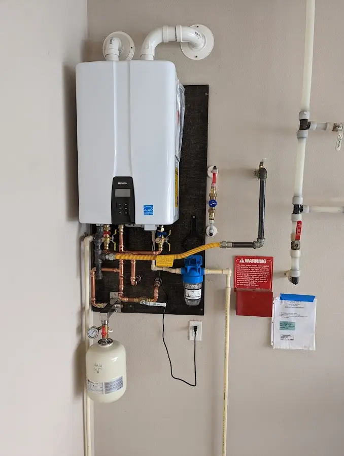 Professional plumber installing copper piping in a Everson home